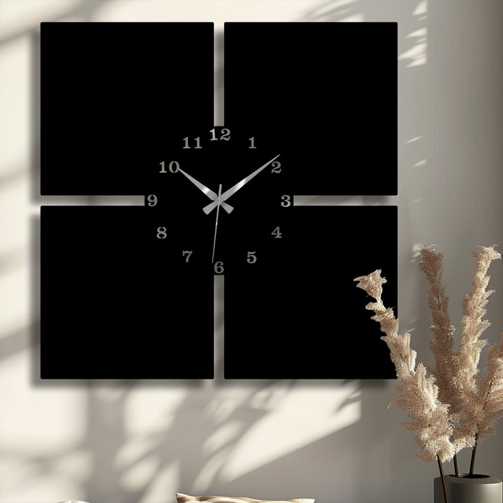 Fluffy dried pampas grass in a dark vase adorns the foreground, complementing the minimal panel metal artwork of the modern 4-piece wall clock.