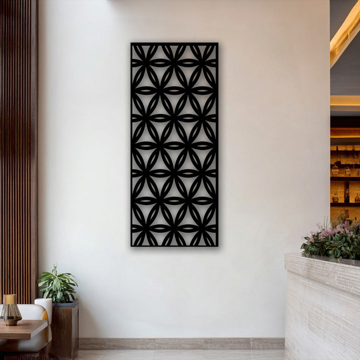 The sleek matte black finish of the geometric floral grid metal artwork creates a striking modern pattern panel.