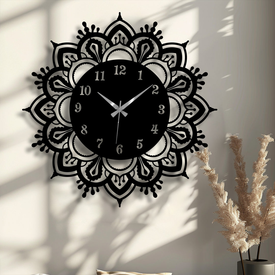 Foreground shows the intricate, cut-out design of this ornate mandala metal wall decor clock, a classic, elegant addition to any room.