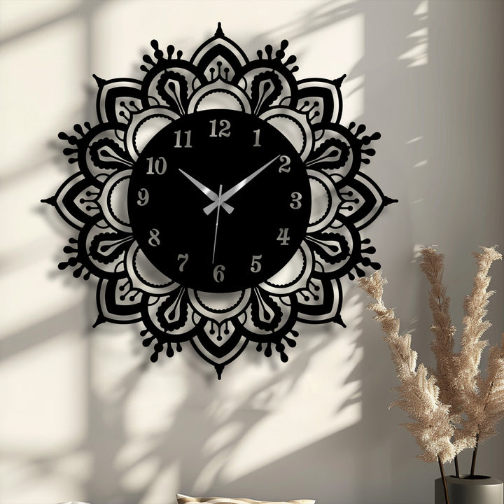 Foreground shows the intricate, cut-out design of this ornate mandala metal wall decor clock, a classic, elegant addition to any room.