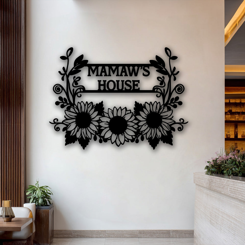 Visual rhythm is evident in the symmetrical flourishes and repeating sunflower motifs of the personalized 'Mamaw's House' unique metal wall art.