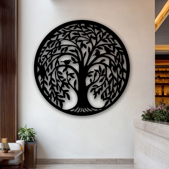 A centrally mounted round metal wall decor piece, showcasing a detailed circular Tree of Life silhouette with birds, nature-inspired.