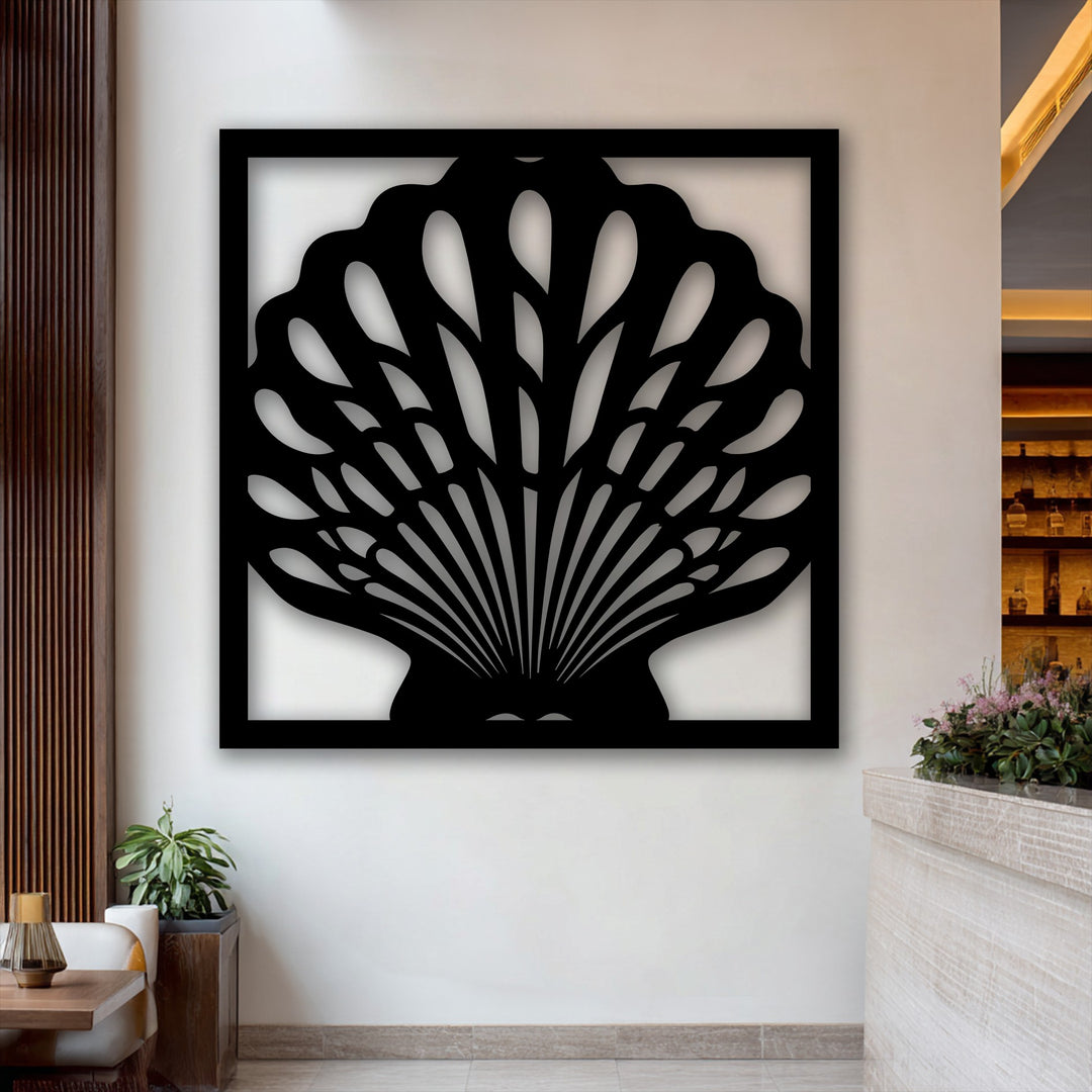 Negative space within the unique metal wall art beautifully forms the intricate fan-like details of a modern seashell frame on a light wall.