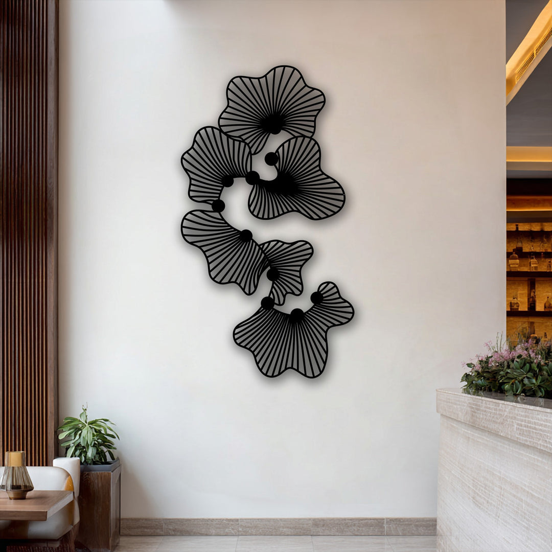 The elegant metal artwork is prominently displayed against a clean, light-toned wall, framed by rich wooden panels and a softly lit bar area.