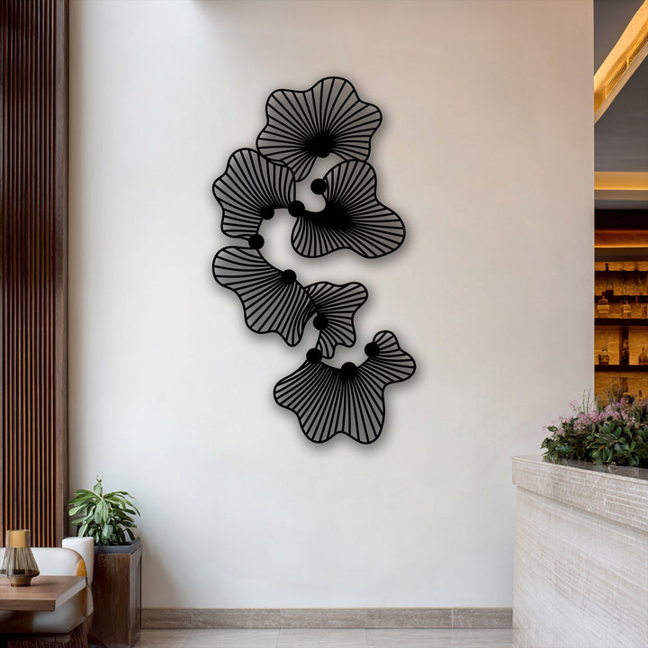 The elegant metal artwork is prominently displayed against a clean, light-toned wall, framed by rich wooden panels and a softly lit bar area.
