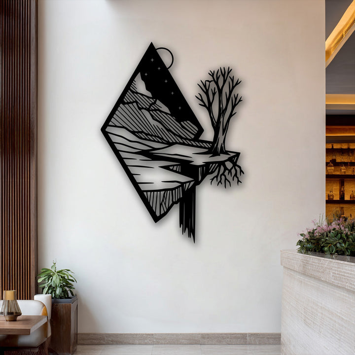Capturing dynamic movement, this unique metal wall art features a floating mountain landscape with a cascading waterfall and a bare tree.