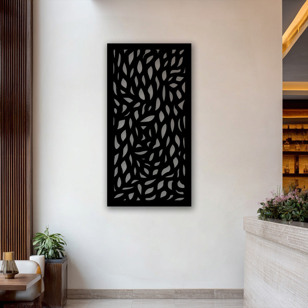 The realistic detail of this abstract leaf pattern panel, a decorative metal art piece, showcases intricate cutouts against a bright white wall.
