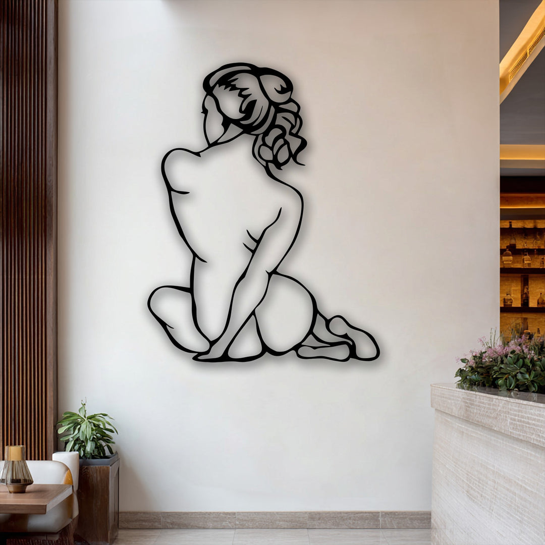 The negative space on the pristine wall artfully defines the graceful contours of the black minimal female figure, an exquisite metal art for wall.