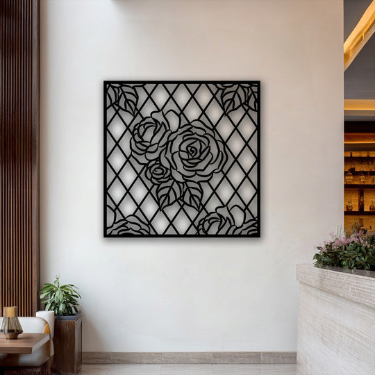 The smooth surface texture of the black rose lattice metal wall decor creates a stark contrast against the white wall.