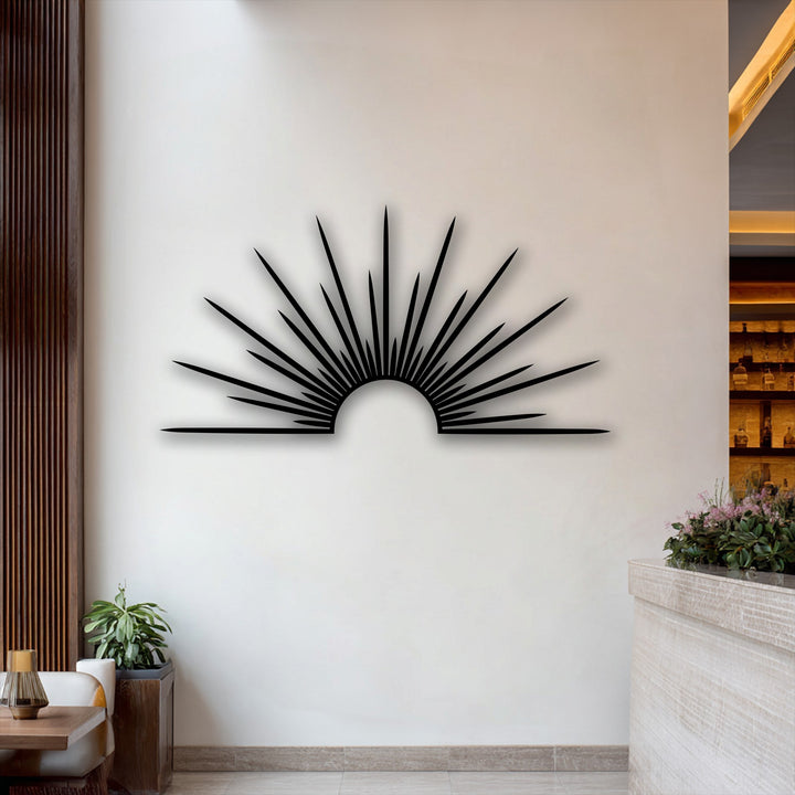 A bright white wall background showcases the minimal sunburst metal art, accented by warm wooden textures and elegant decoration wall art.