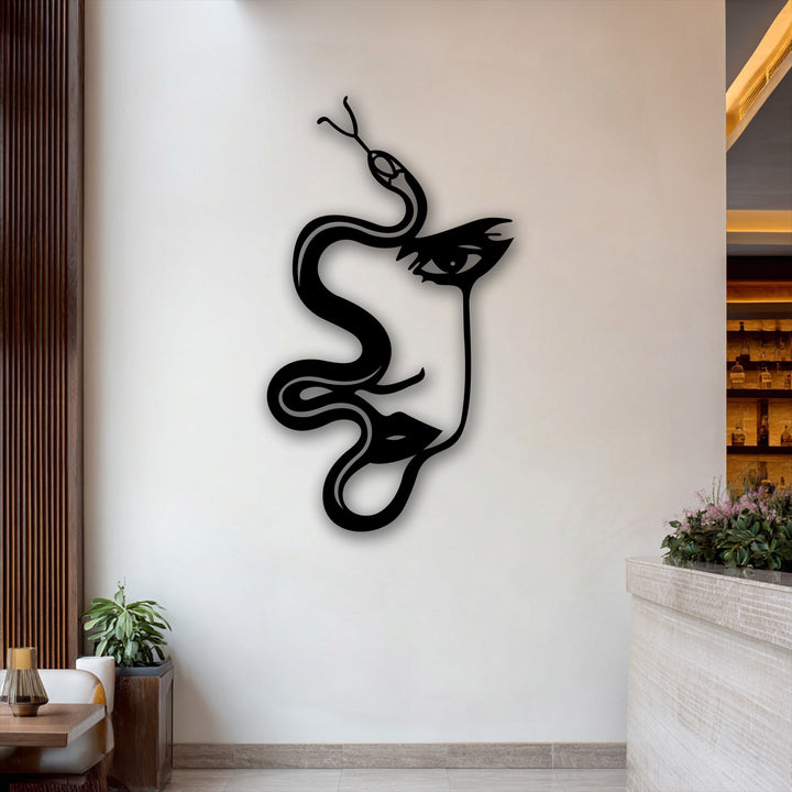 The subdued color saturation highlights the stark black abstract woman and serpent silhouette metal wall decor against muted background elements.