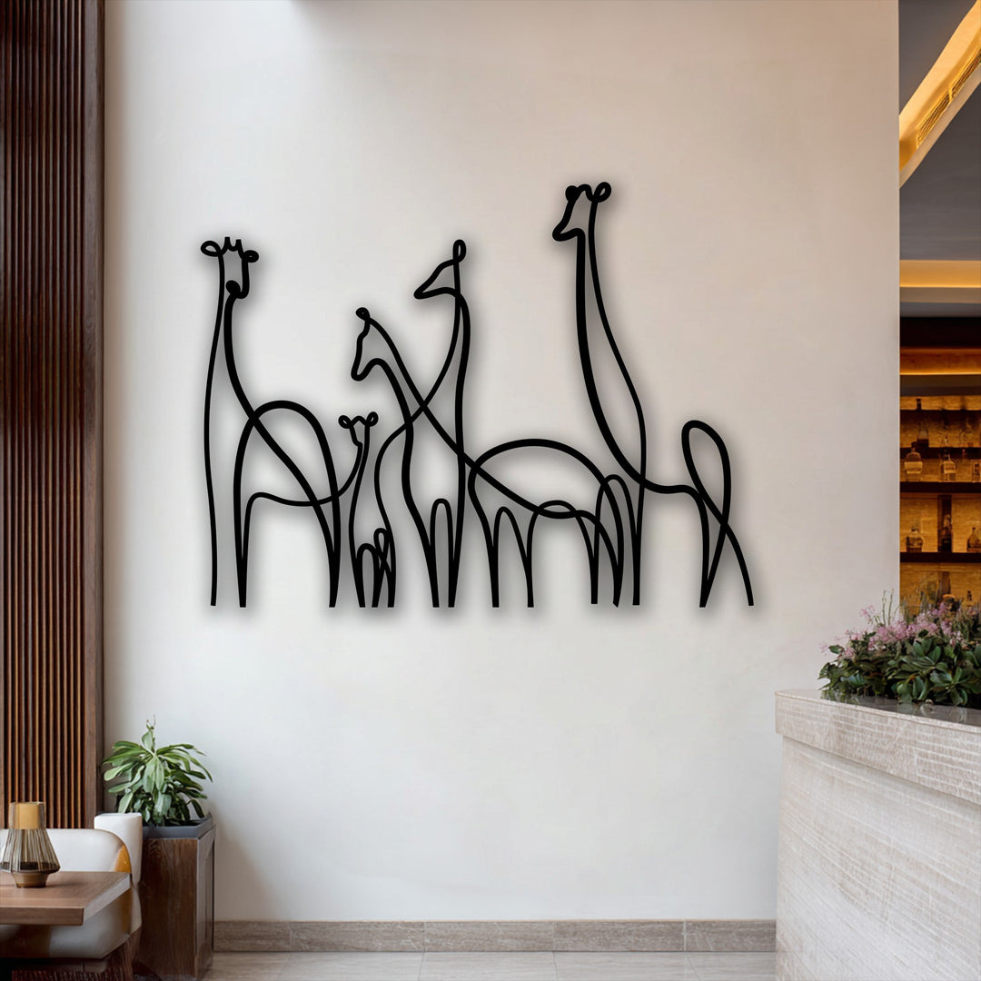 Smooth, distinct lines of unique metal wall art featuring a minimalist giraffe family design cast subtle shadows against a white wall.