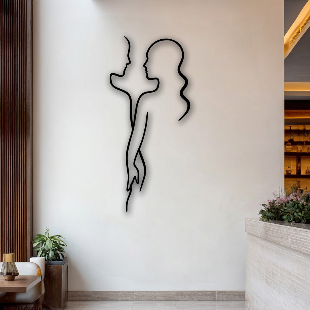 Delicate pink blooms on a counter soften the sleek lines of the modern love silhouette decoration wall art, creating an inviting ambiance.