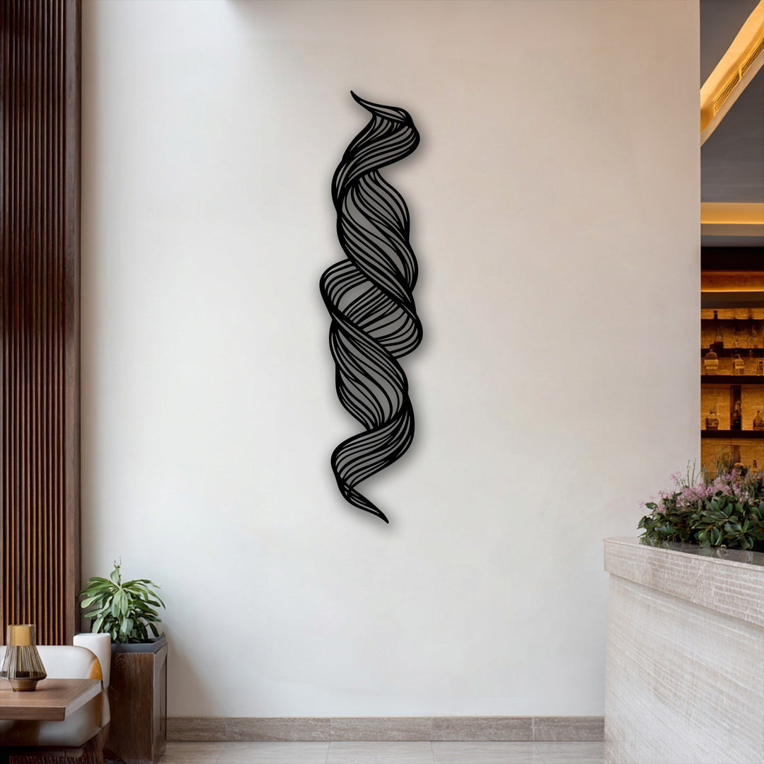 The warm color temperature of the room complements the unique metal wall art, featuring a twisted flow abstract design.