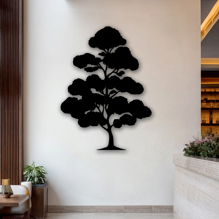 A striking black Zen bonsai tree silhouette, crafted as metal art for wall, stands prominently against a soft cream wall.