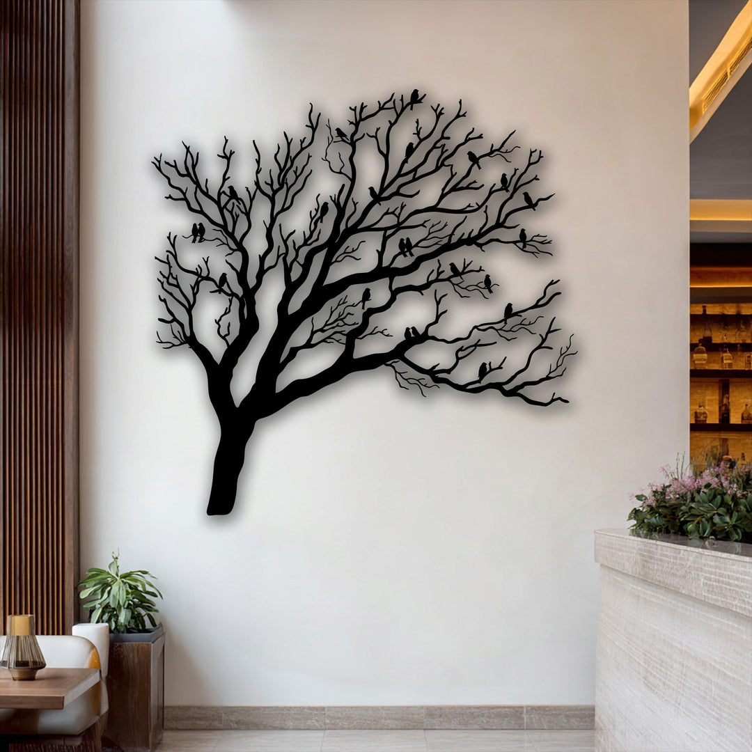 The pristine, light wall background, subtly accented by wood, showcases the unique metal wall art of a bare tree with birds silhouette.