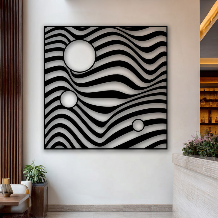 The depth and layers of this unique metal wall art are created by its undulating black waves and three circular cutouts.