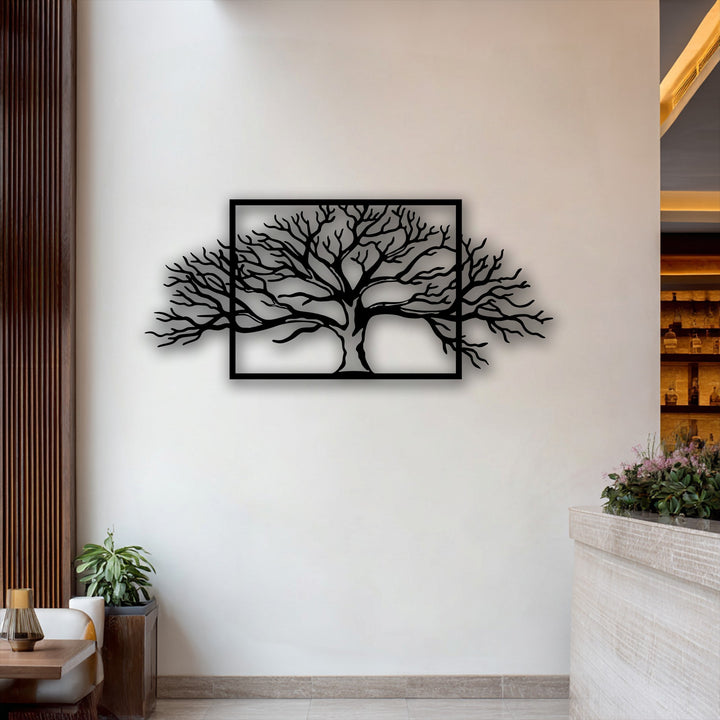 The negative space around the intricate black framed tree metal wall decor emphasizes its abstract nature branch design against a light wall.