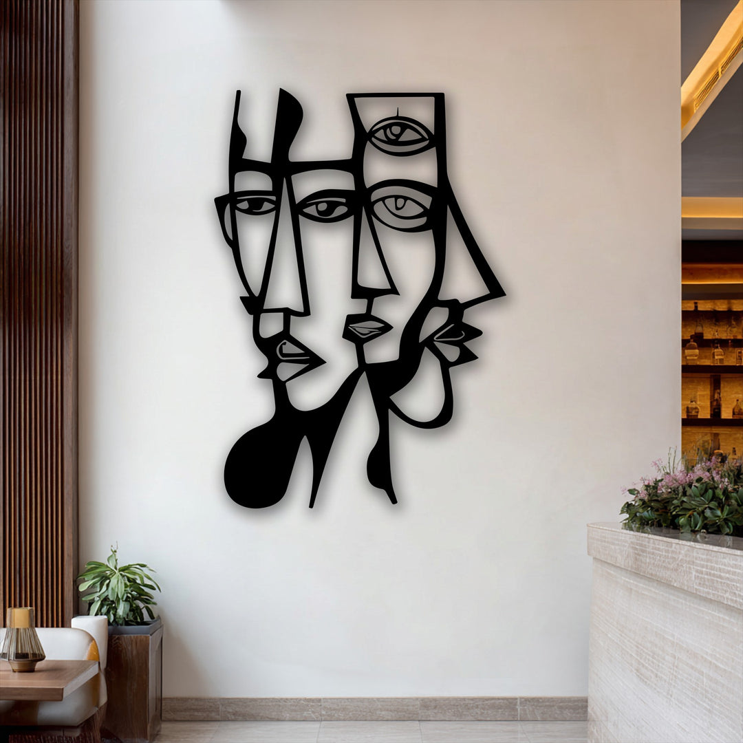 The negative space expertly defines the abstract dual faces and geometric lines of this striking decorative metal art piece.