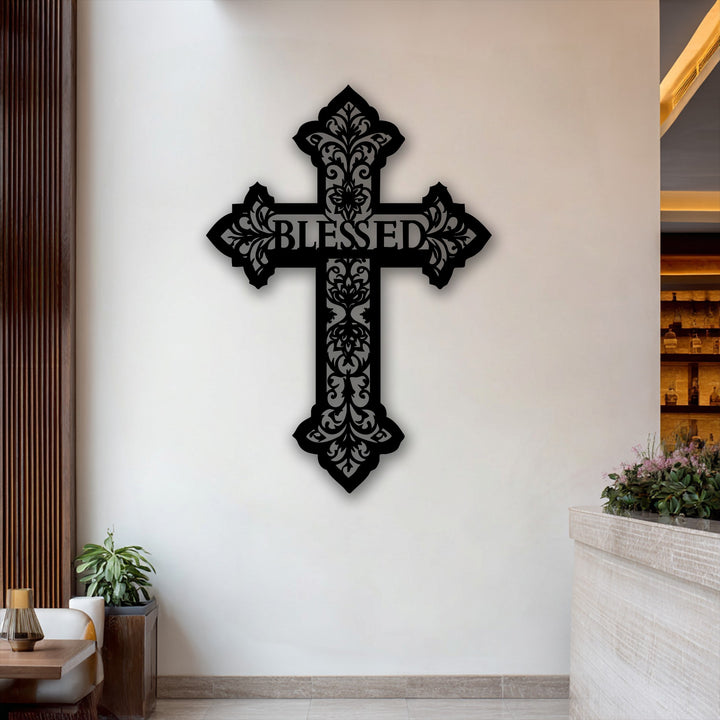 The stark color contrast of the dark, filigree Blessed Cross metal art for wall against the light, neutral wall creates an elegant display.