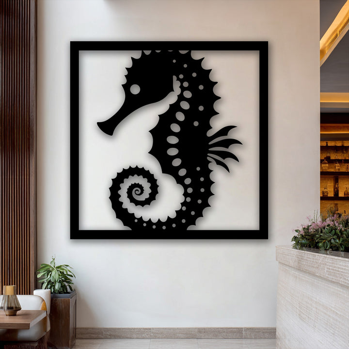 Dramatic shadows are cast by the black seahorse frame metal art for wall, highlighting its intricate silhouette against a brightly lit wall.