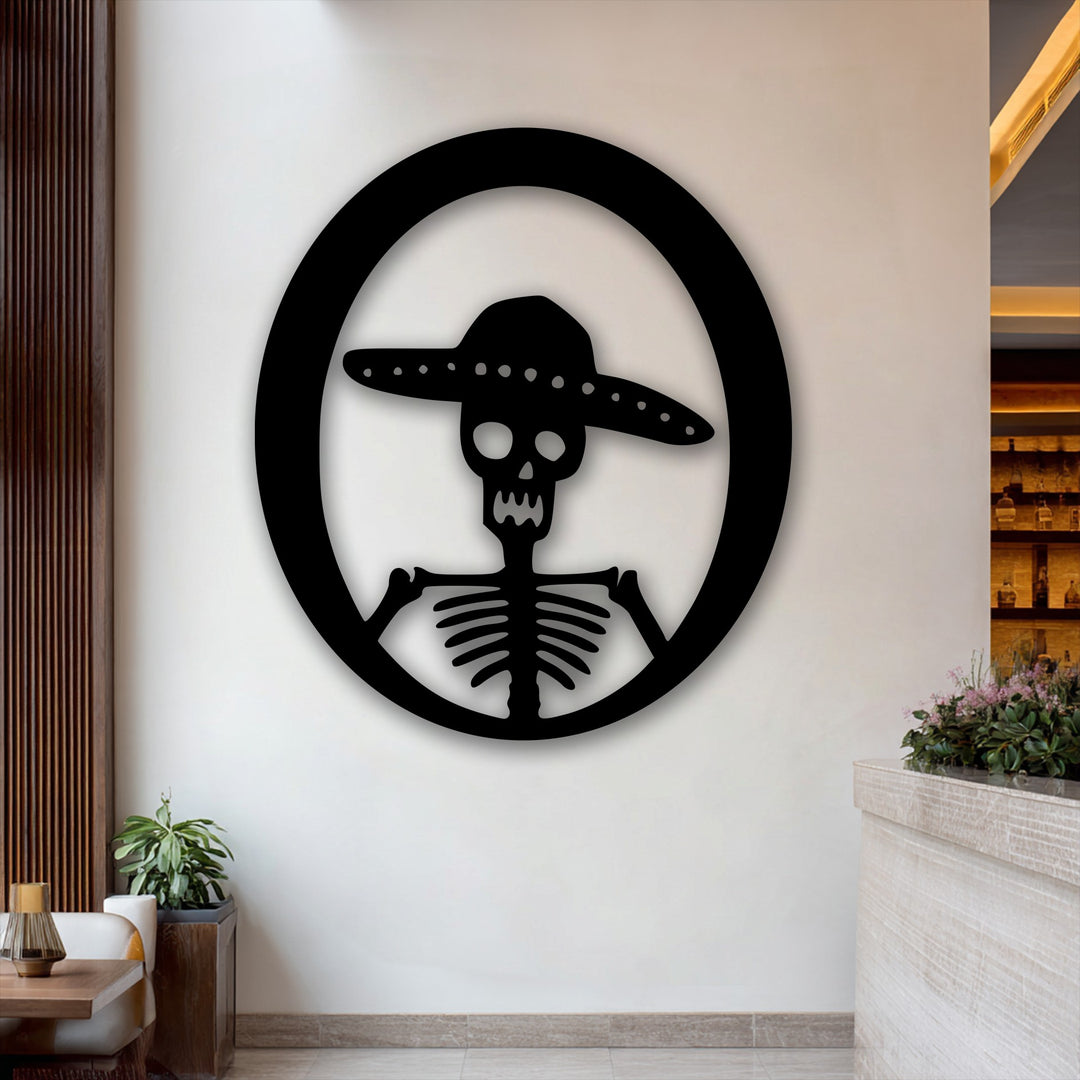 The muted color saturation highlights the stark black Sombrero Skeleton unique metal wall art against a neutral backdrop.