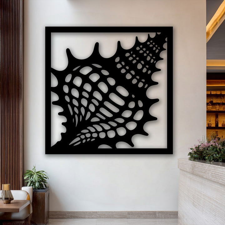 An elegant and sophisticated mood emanates from the intricate seashell frame metal wall decor, creating a calm focal point in a modern interior.