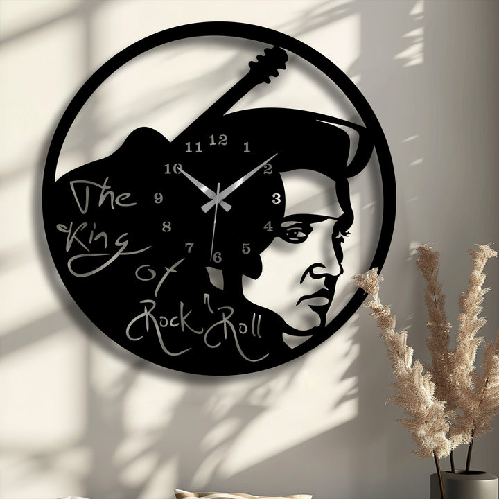 The negative space of this rock music icon metal wall decor clock strikingly defines Elvis Presley's profile and a vintage guitar, contrasting against the wall.