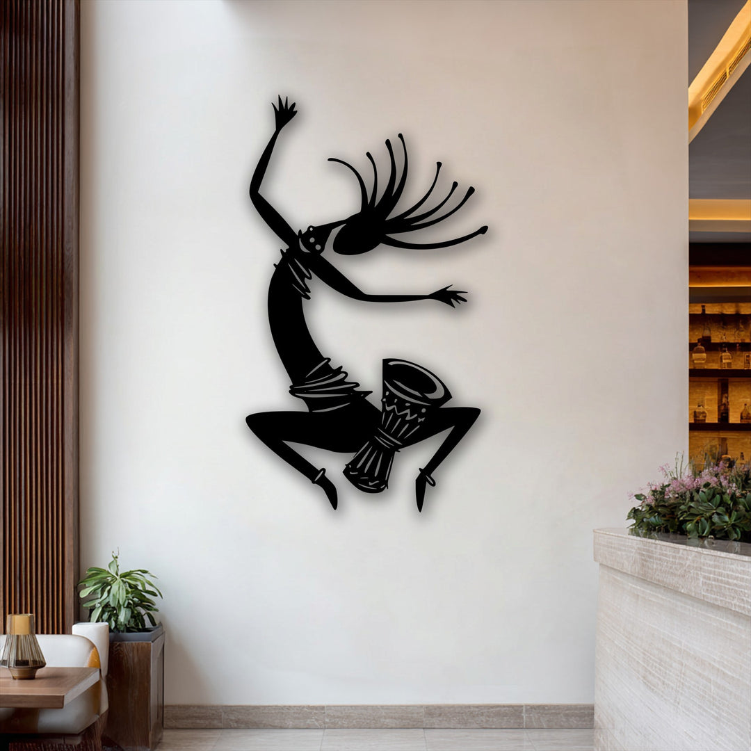 The energetic tribal dancer silhouette, a striking metal wall decor piece, vividly stands out against a bright background.
