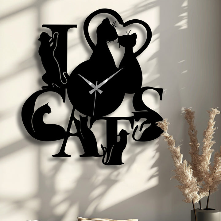 The abstract silhouette of a unique metal wall art clock forms the phrase 'I LOVE CATS,' blending romantic cat figures into its design.