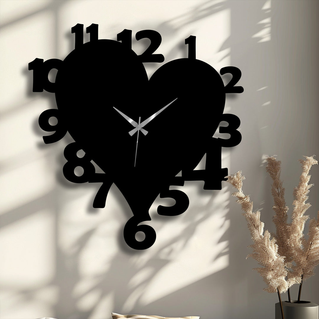 The brightest area of the wall highlights the bold black number 11 on the heart shape metal wall clock, a modern decoration wall art piece.