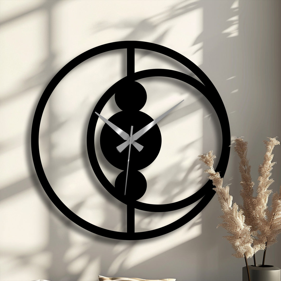 Visual rhythm is achieved through the circles and lines of this abstract circular metal artwork wall clock, offering a modern minimalist decor accent.