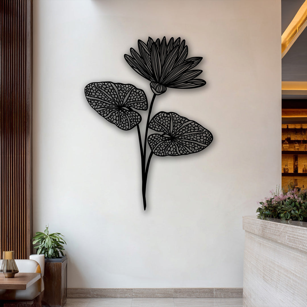 Vertically oriented, this elegant botanical metal art for wall features a flowing lotus silhouette with a bloom and two leaves.
