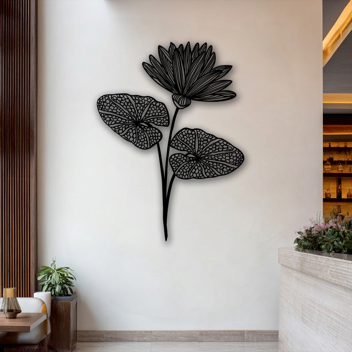 Vertically oriented, this elegant botanical metal art for wall features a flowing lotus silhouette with a bloom and two leaves.