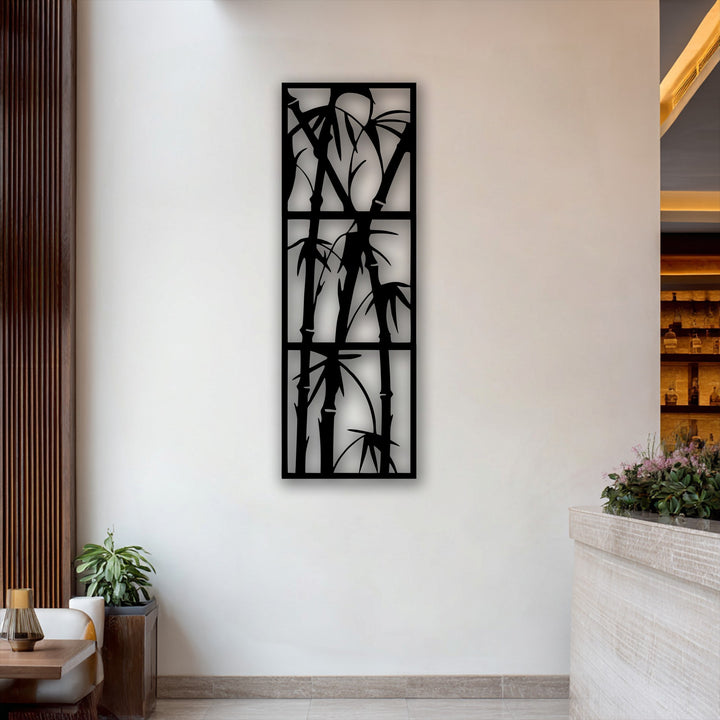 The intricate negative space around the black bamboo metal wall decor beautifully highlights the stark white wall, emphasizing its minimalist nature.