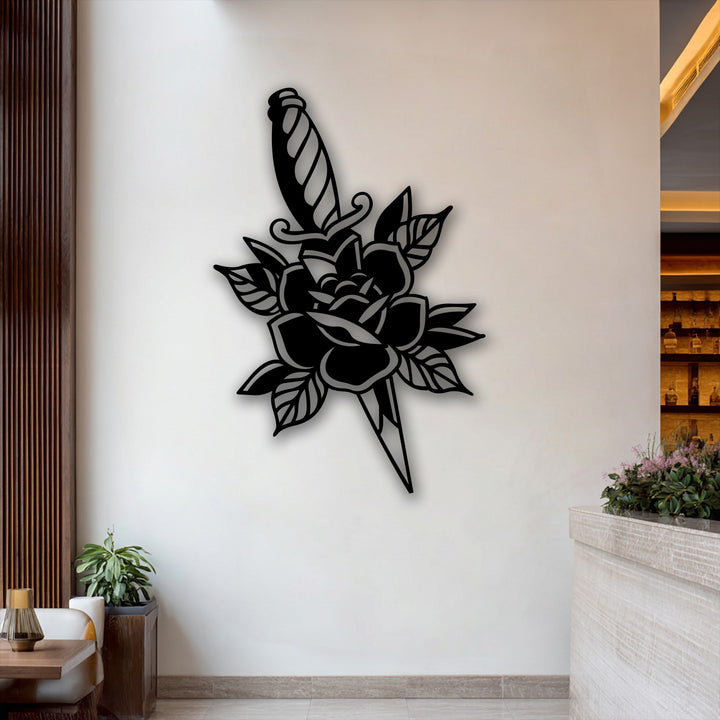 The intricate petals of the silhouette rose create a striking decorative metal art piece alongside the sharp dagger.