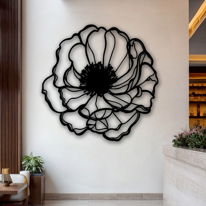 The smooth color transition from the bold black metal wall decor outline to the softly shadowed, light-toned wall.