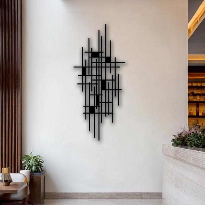 Negative space accentuates the striking geometric grid metal artwork, forming an abstract minimalist design against a clean white wall.