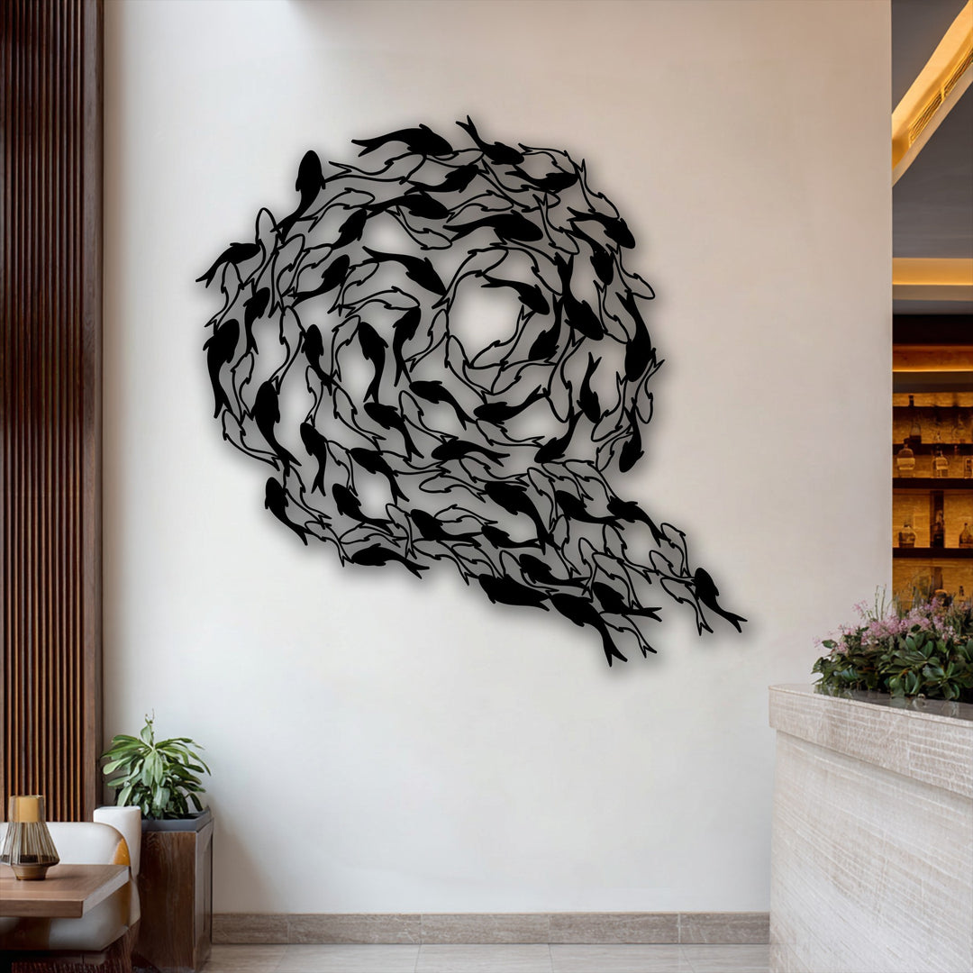 The intricate layering effect of countless black koi fish creates a captivating circular design, forming a stunning decorative metal art piece.