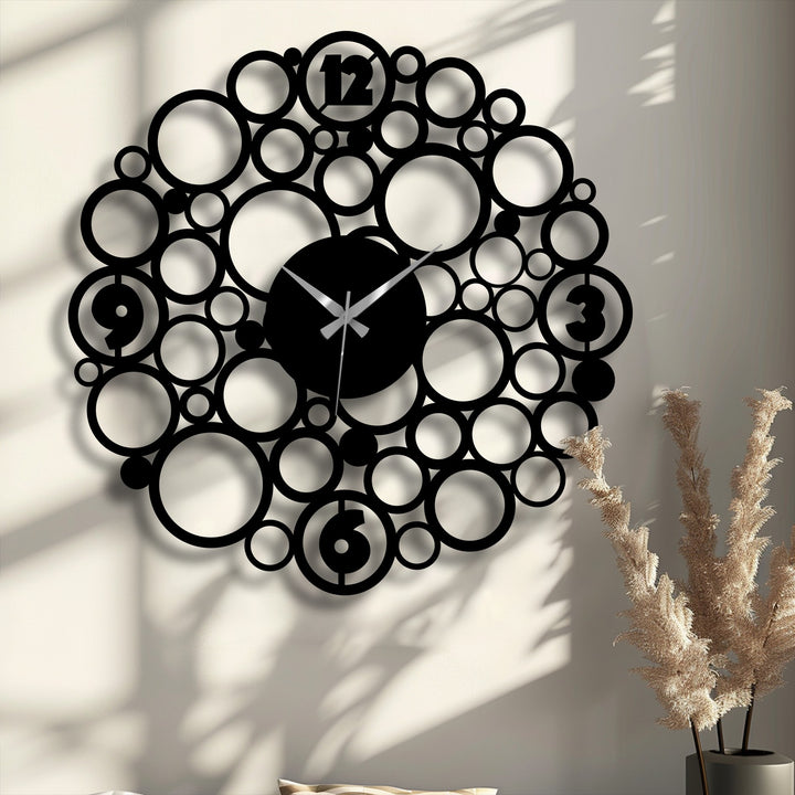 Illuminated by the brightest area, the decoration wall art showcases a bubble circle metal wall clock with a modern abstract design.