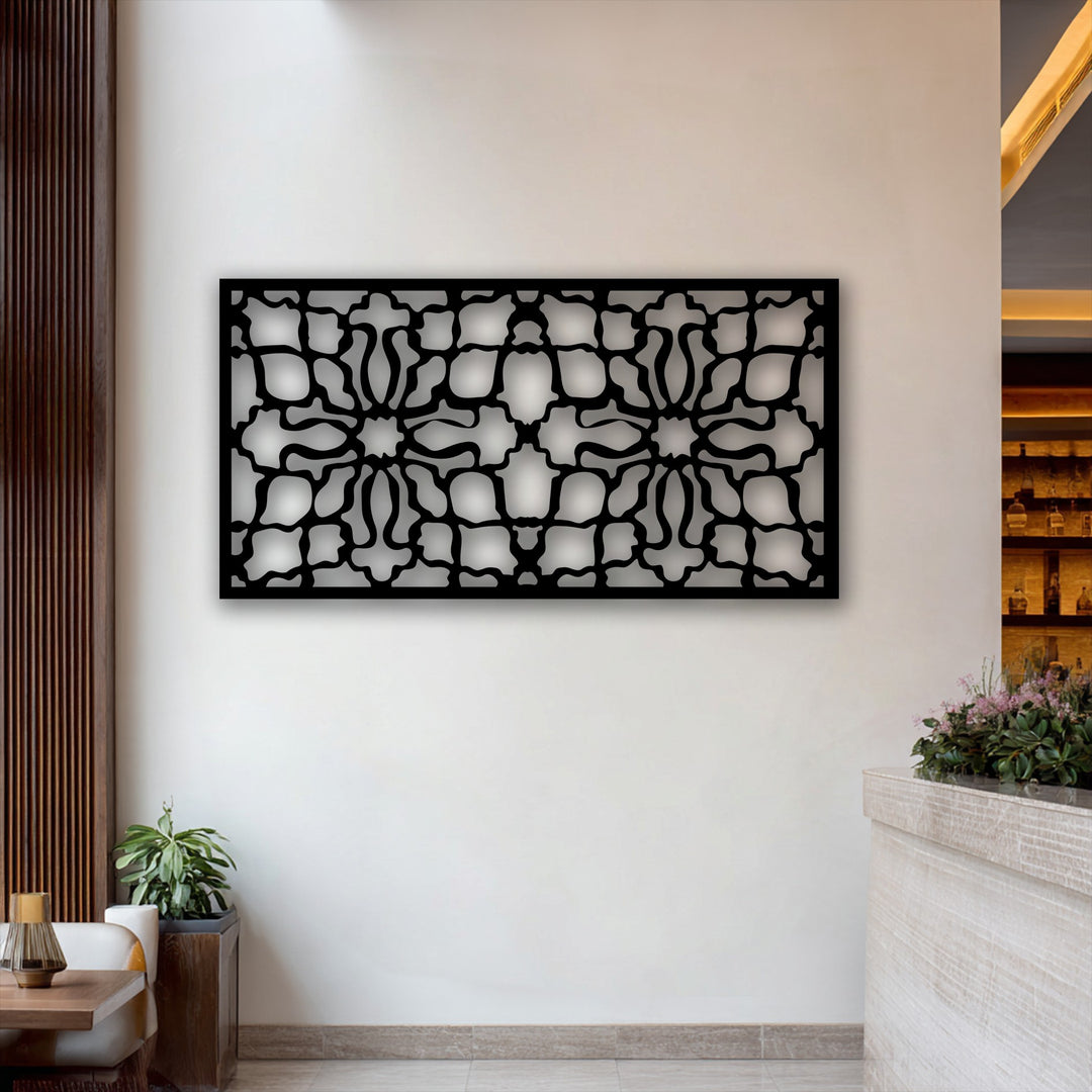 A horizontally oriented rectangular ornamental geometric metal artwork panel features an intricate pattern.