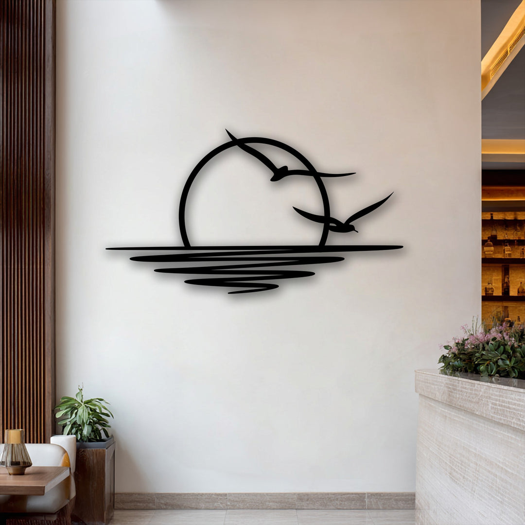 The negative space distinctly outlines a sleek, black metal sunset and flying seagulls, forming minimalist coastal decoration wall art.