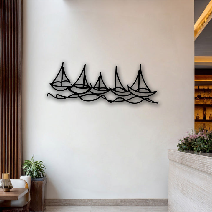 The serene ambiance is enhanced by a minimalist metal wall decor depicting five stylized sailboats gracefully navigating undulating waves.