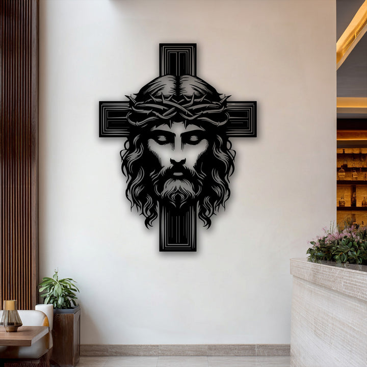 The darkest area reveals a striking decorative metal art piece of Jesus's face with a crown of thorns on a cross.
