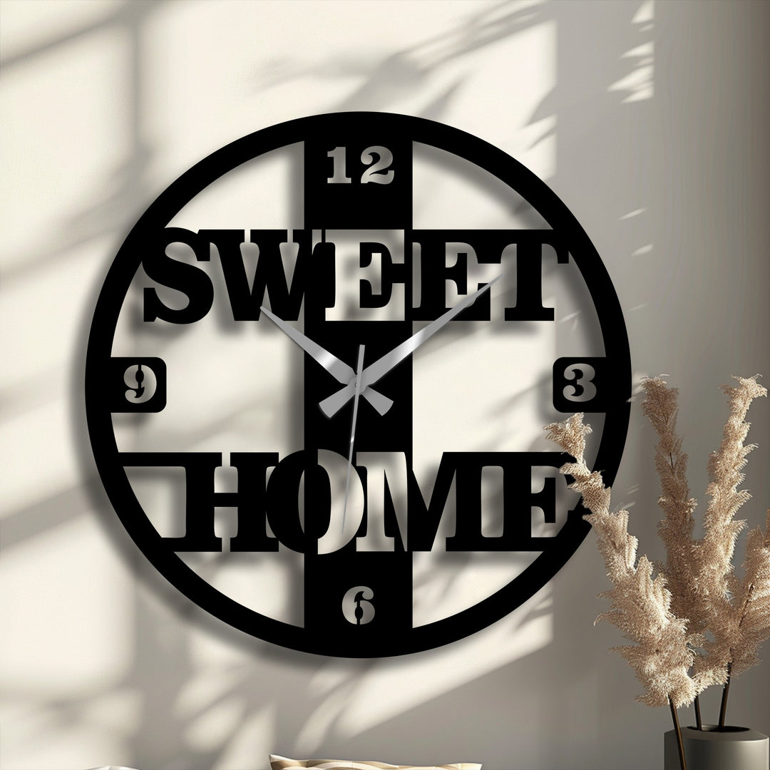 Spinning shadows accentuate the decorative metal art design of this 'Sweet Home' wall clock, giving a sense of time flowing in a modern aesthetic.