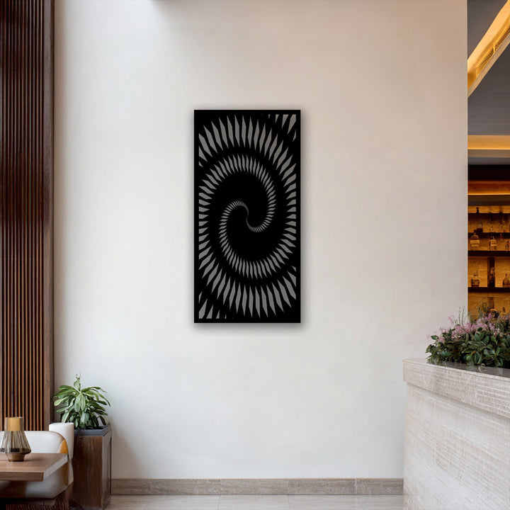 The unique metal wall art features a precise, laser-cut surface texture creating a hypnotic spiral geometry optical illusion.