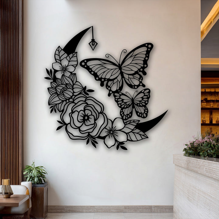With minimal color saturation, the striking black Moon Butterfly metal artwork featuring delicate floral crescent designs provides a bold contrast.