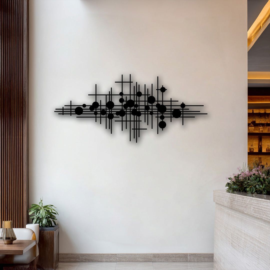 Delicate pink and purple flowers offer a soft, organic contrast to the striking geometric metal wall decor, enhancing the room's abstract modern aesthetic.