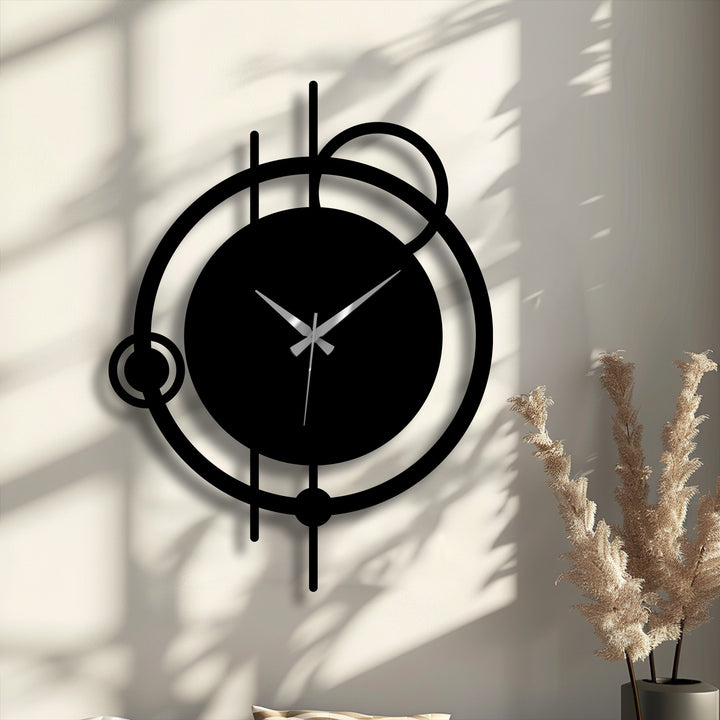 The wall's color transition from bright white to soft shadows highlights the black abstract metal wall clock, a striking metal wall decor.