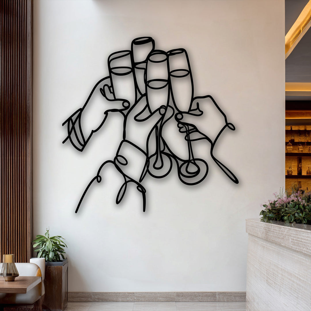 The darkest area prominently features a striking black metal wall decor, showcasing celebration line art of hands toasting with champagne flutes.